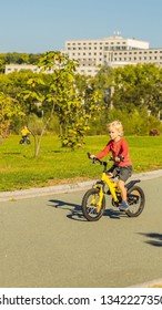 Two Happy Boys Cycling In The Park VERTICAL FORMAT For Instagram Mobile Story Or Stories Size. Mobile Wallpaper