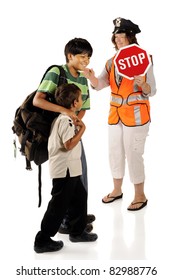 Two Happy Brothers Headed For School With The Assistance Of A Crossing Guard.  Isolated.