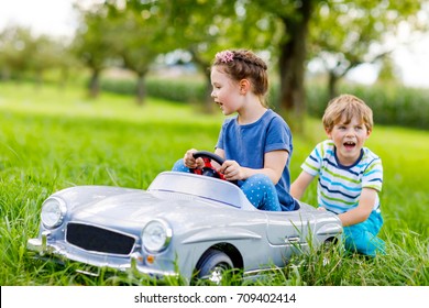 kids pushing car