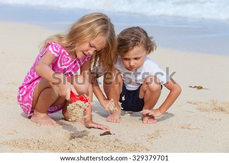 Similar – Two kids digging on the beach