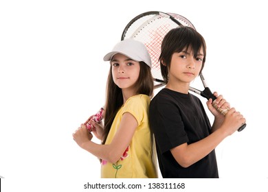 two happy children posing with tennis racquets on white background