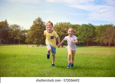 Two Happy Children Running In Summer Park 