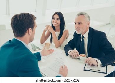 Two Happy Colleagues On Meeting With Their Business Partner