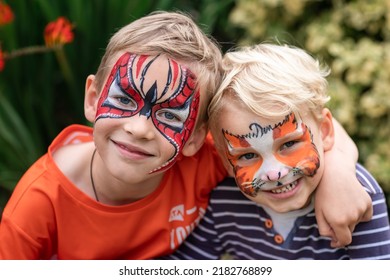 Two happy cute little boys and their faces painted  Face painting  kids painting face at the birthday party holidays