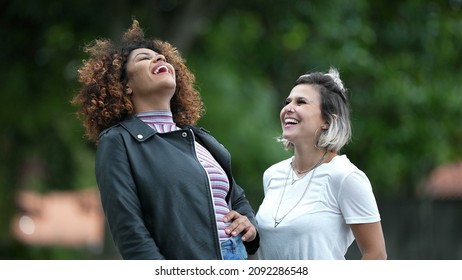 Two Happy Diverse Women Standing Outside Smiling