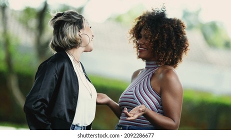 Two Happy Diverse Women Standing Outside Smiling