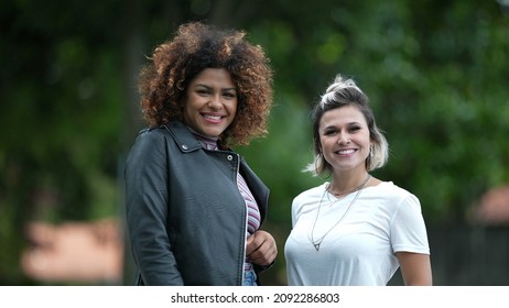 Two Happy Diverse Women Standing Outside Smiling