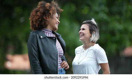 Two Happy Diverse Women Standing Outside Smiling