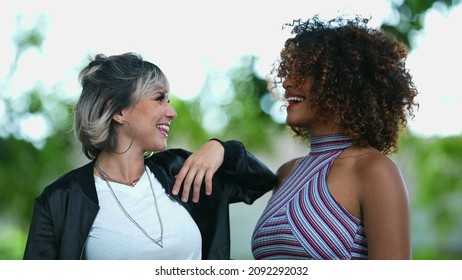 Two Happy Diverse Women Standing Outside Smiling