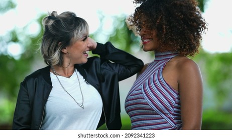 Two Happy Diverse Women Standing Outside Smiling