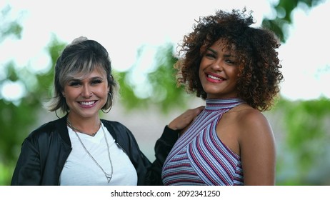 Two Happy Diverse Women Standing Outside Smiling