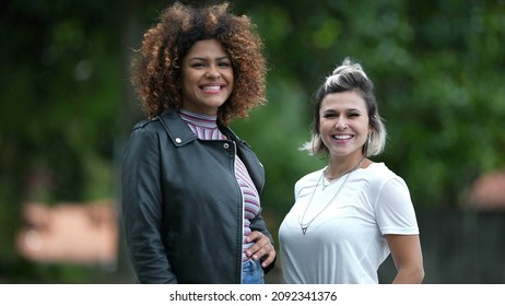 Two Happy Diverse Women Standing Outside Smiling