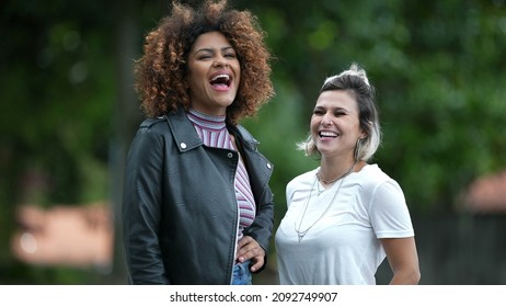 Two Happy Diverse Women Standing Outside Smiling