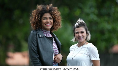 Two Happy Diverse Women Standing Outside Smiling