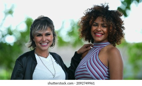 Two Happy Diverse Women Standing Outside Smiling