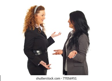Two happy executives women having funny conversation and both gesticulate with hands isolated on white background