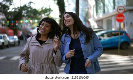 Two Happy Female Friends Dancing Outside In City Street Celebrating Life. Happy Women Dancers