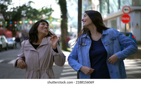 Two Happy Female Friends Dancing Outside In City Street Celebrating Life. Happy Women Dancers