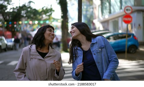 Two Happy Female Friends Dancing Outside In City Street Celebrating Life. Happy Women Dancers