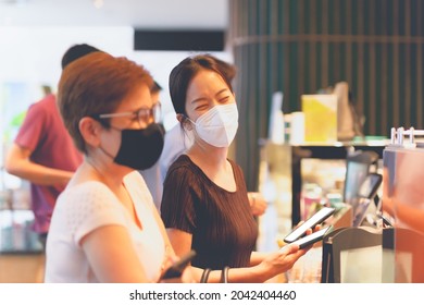 Two Happy Female Friends In Protective Mask Buying Coffee