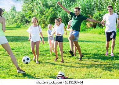 Two happy french friendly families with children playing football in nature at summer - Shutterstock ID 1013108764