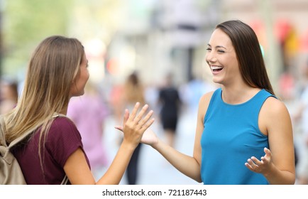 Two Happy Friends Greeting And Meeting On The Street