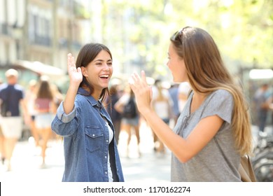 Two Happy Friends Meeting And Greeting In The Street