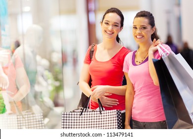 Two Happy Friends Shopping In Mall