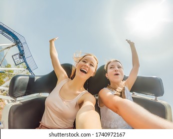 Two happy girls having fun on rollercoaster - Shutterstock ID 1740972167