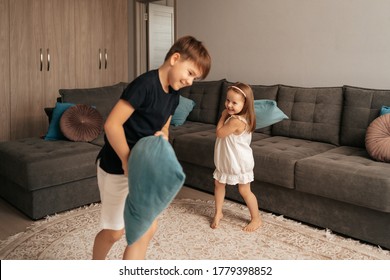 Two Happy Kids Fighting With Pillows At Home. Happy Childhood