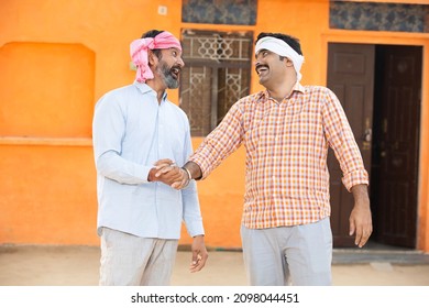 Two Happy Laughing L Indian Farmer Having Fun With Each Other With Outside Their Village House, Cheerful Men Friends Wearing Traditional Kurta And Head Wrap Cloth Spending Good Time, Rural India