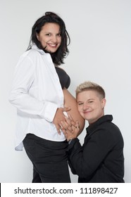 two happy lesbian women, one of them pregnant, happy becoming a family