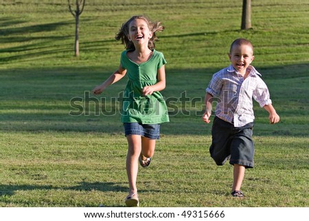Image, Stock Photo Two teenagers race through the sunshine on a sled, dusted with snow