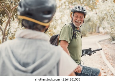 Two happy old mature people enjoying and riding bikes together to be fit and healthy outdoors. Active seniors having fun training in nature. Portrait of one old man smiling in a bike trip with wife - Shutterstock ID 2164281033