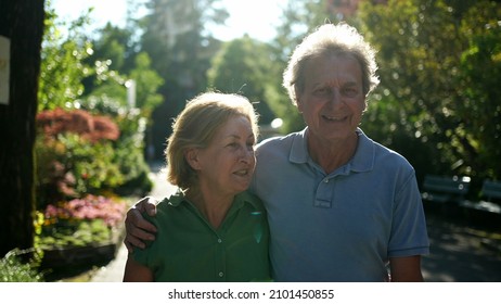 Two Happy Older People Walking Outside Smiling, Senior Couple Together In Outdoor Nature Walk