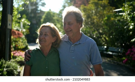 Two Happy Older People Walking Outside Smiling, Senior Couple Together In Outdoor Nature Walk