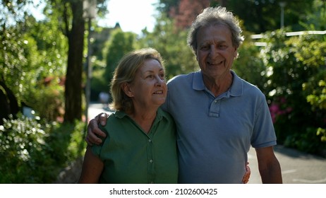 Two Happy Older People Walking Outside Smiling, Senior Couple Together In Outdoor Nature Walk