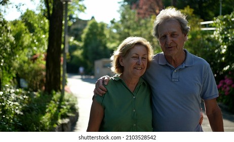 Two Happy Older People Walking Outside Smiling, Senior Couple Together In Outdoor Nature Walk