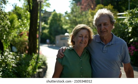 Two Happy Older People Walking Outside Smiling, Senior Couple Together In Outdoor Nature Walk