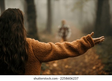 Two happy people are about to hug during outdoor activity. Focus on the woman with spread hands. - Shutterstock ID 2258606237