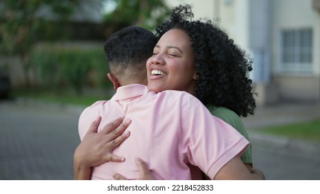 Two happy people embracing celebrating reunion. Young woman hugging family member outdoors. Homecoming concept of friends embrace. Real life authentic friendship - Powered by Shutterstock