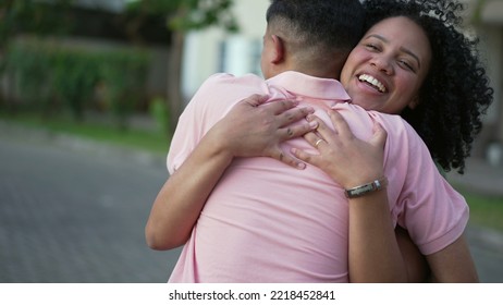 Two Happy People Embracing Celebrating Reunion. Young Woman Hugging Family Member Outdoors. Homecoming Concept Of Friends Embrace. Real Life Authentic Friendship