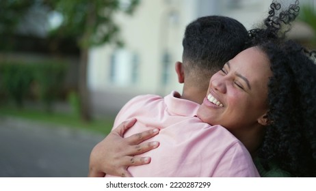 Two Happy People Embracing Celebrating Reunion. Young Woman Hugging Family Member Outdoors. Homecoming Concept Of Friends Embrace. Real Life Authentic Friendship