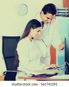 Two Happy Professional Doctors Brainstorming And Sharing Information In Clinic