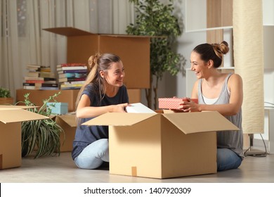 Two Happy Roommates Talking Unboxing Gelongings Moving Home Sitting On The Floor