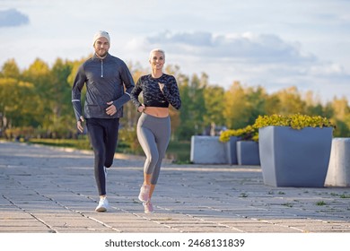 Two Happy Runners as Couple Training Together At Running Training Fitness Exercise At Nature Outside During Training Outdoor. Horizontal Image Compositon - Powered by Shutterstock