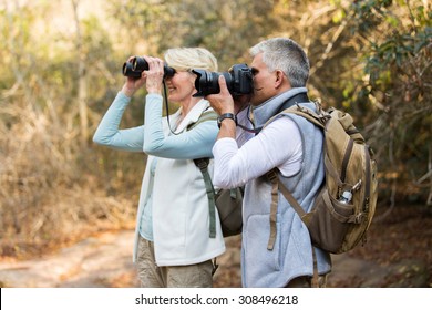 two happy senior hikers at valley of the mountain - Powered by Shutterstock