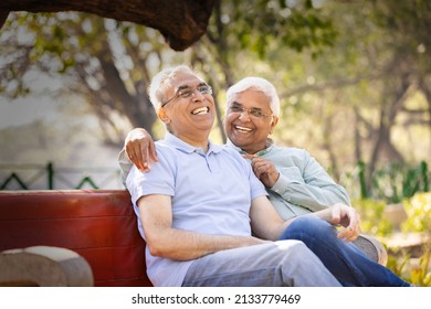 Two Happy Senior Male Friends Spending Leisure Time At Park