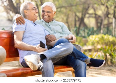 Two Happy Senior Male Friends Spending Leisure Time At Park