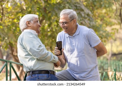 Two Happy Senior Male Friends Spending Leisure Time At Park